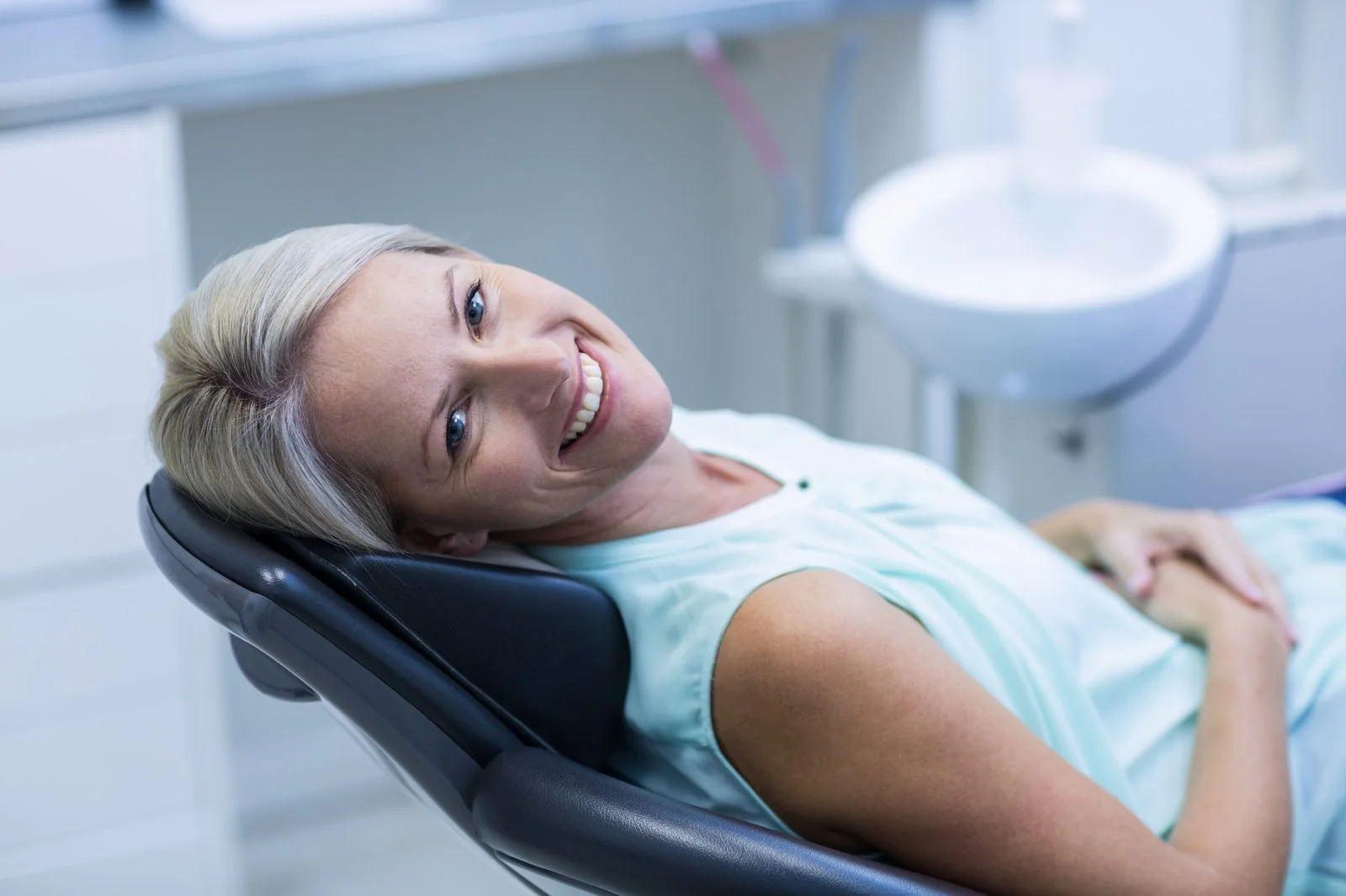 Woman smiling during a calm dental appointment